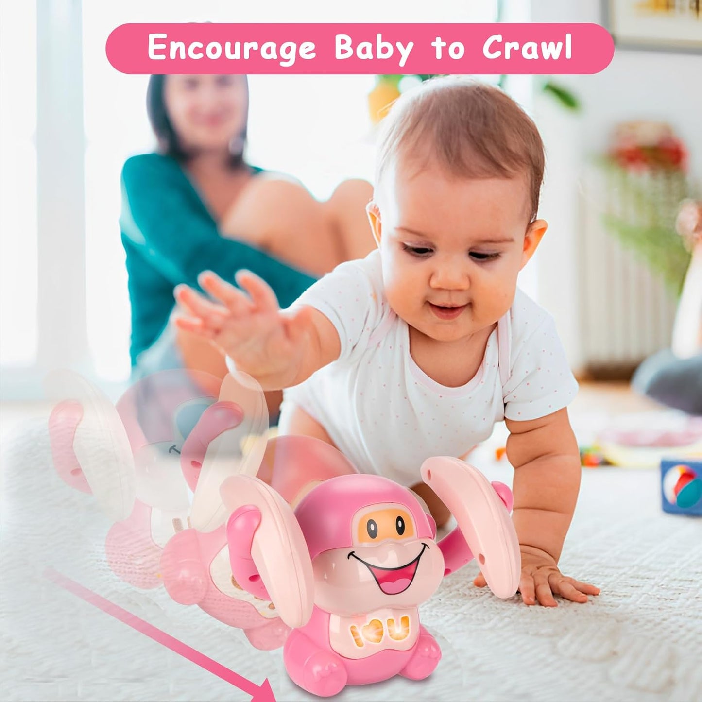 Baby playing with a pink toy designed to encourage crawling, with a blurred background of a woman and child.